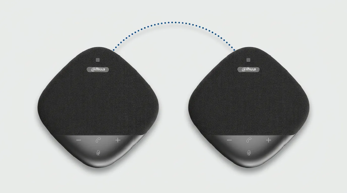 Two DHI-PKC-WM1A speakerphones side by side, as used when cascading two units